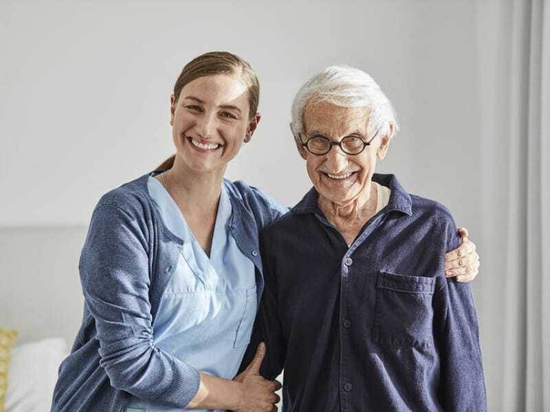 Care associate with senior male resident